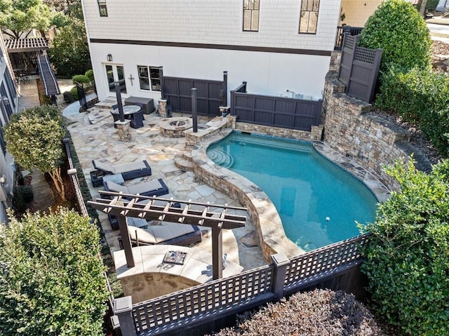 view of swimming pool featuring a patio and a fire pit