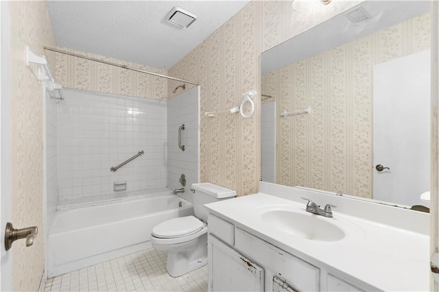 full bathroom featuring a textured ceiling, tiled shower / bath, tile patterned flooring, toilet, and vanity