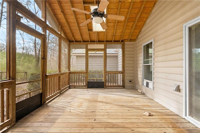 unfurnished sunroom featuring ceiling fan, wooden ceiling, and lofted ceiling