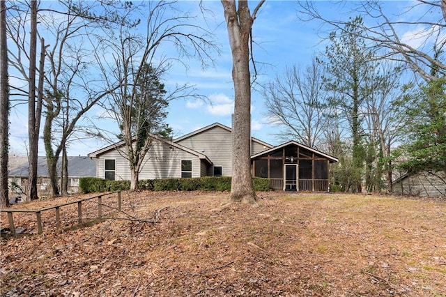 rear view of property with a sunroom