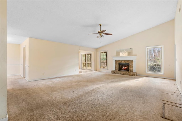 unfurnished living room with light colored carpet, ceiling fan, and vaulted ceiling