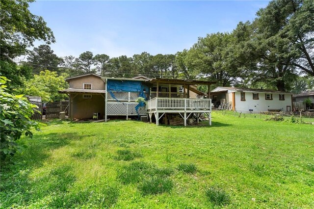 1550 Bells Ferry Rd, Marietta, GA 30066 - rear view of house with a deck and view of scattered trees