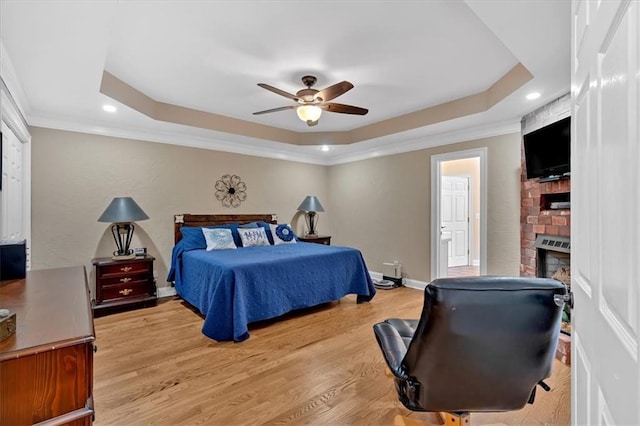 11 Crossbridge Ct SW, Cartersville, GA 30120 - bedroom featuring a tray ceiling, a fireplace, light wood-style floors, ornamental molding, and recessed lighting