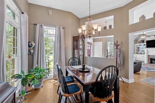 11 Crossbridge Ct SW, Cartersville, GA 30120 - dining space with wood finished floors, a chandelier, ceiling fan, a fireplace, and baseboards