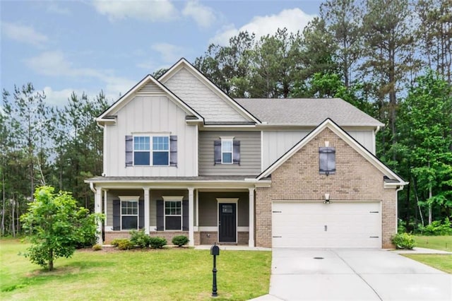craftsman house with board and batten siding, concrete driveway, a front lawn, and brick siding