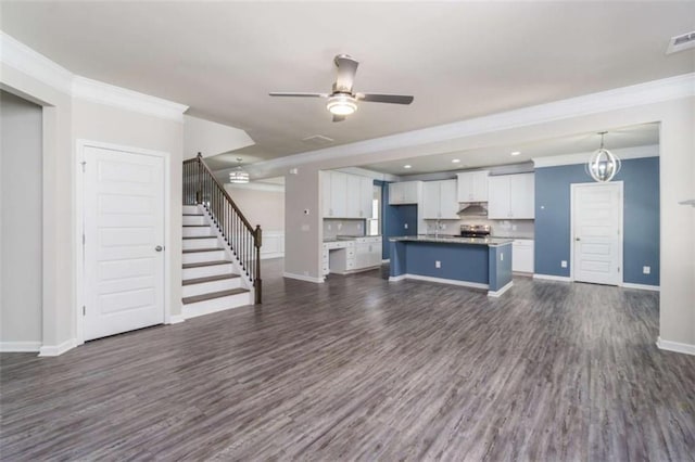 unfurnished living room with ornamental molding, dark wood-style floors, stairs, baseboards, and recessed lighting