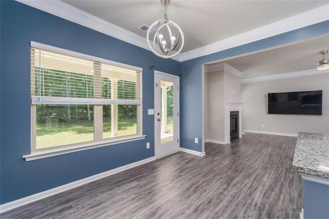 unfurnished living room with ornamental molding, a chandelier, dark wood-style floors, baseboards, and a fireplace