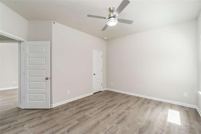 unfurnished bedroom featuring wood finished floors, baseboards, and ceiling fan