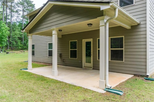 back of property with a patio area and a lawn