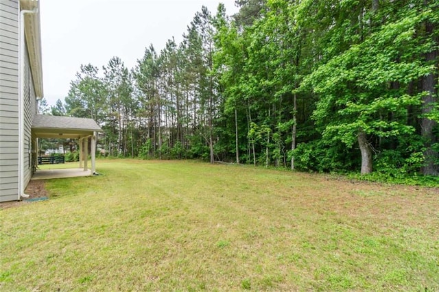 view of grassy yard with a patio