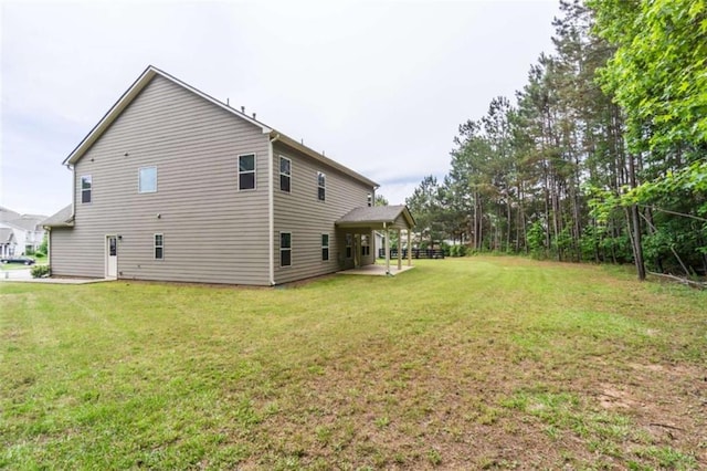view of home's exterior featuring a lawn and a patio area