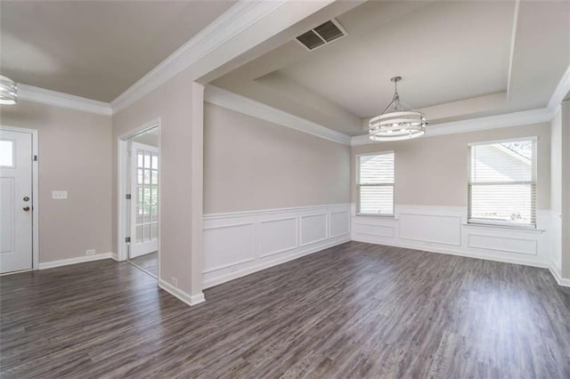 unfurnished dining area featuring a chandelier, dark wood-style flooring, plenty of natural light, a wainscoted wall, and crown molding