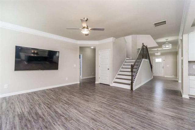 unfurnished living room with stairs, ceiling fan, wood finished floors, crown molding, and baseboards