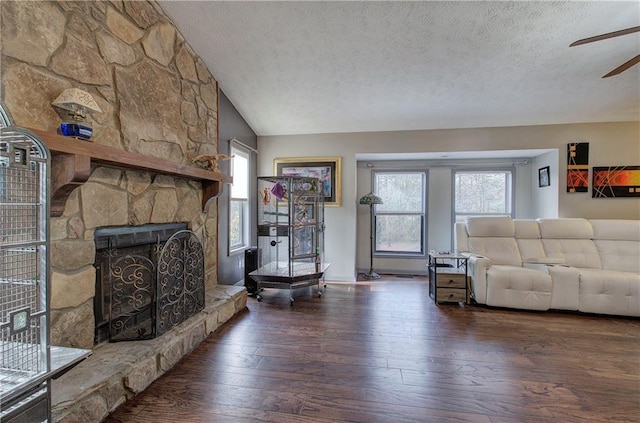 unfurnished living room featuring a fireplace, plenty of natural light, dark hardwood / wood-style floors, and lofted ceiling