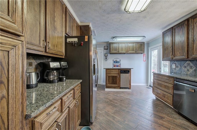 kitchen with stone counters, crown molding, stainless steel appliances, dark hardwood / wood-style flooring, and decorative backsplash