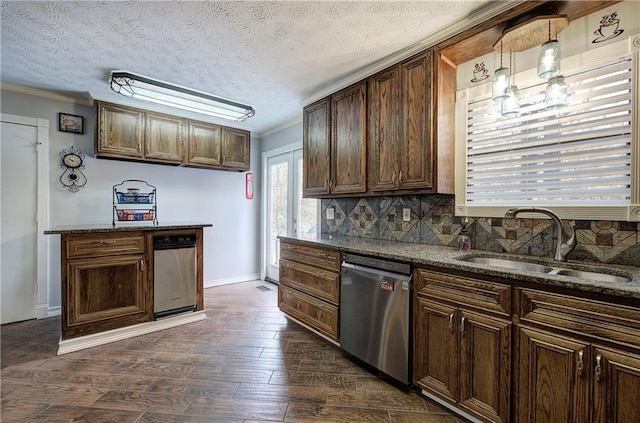 kitchen featuring dark stone countertops, sink, stainless steel dishwasher, and decorative backsplash