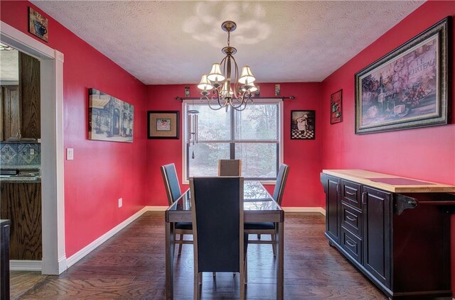 dining room featuring an inviting chandelier, dark hardwood / wood-style flooring, and a textured ceiling