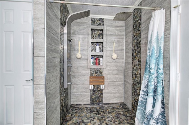 bathroom featuring a textured ceiling and walk in shower