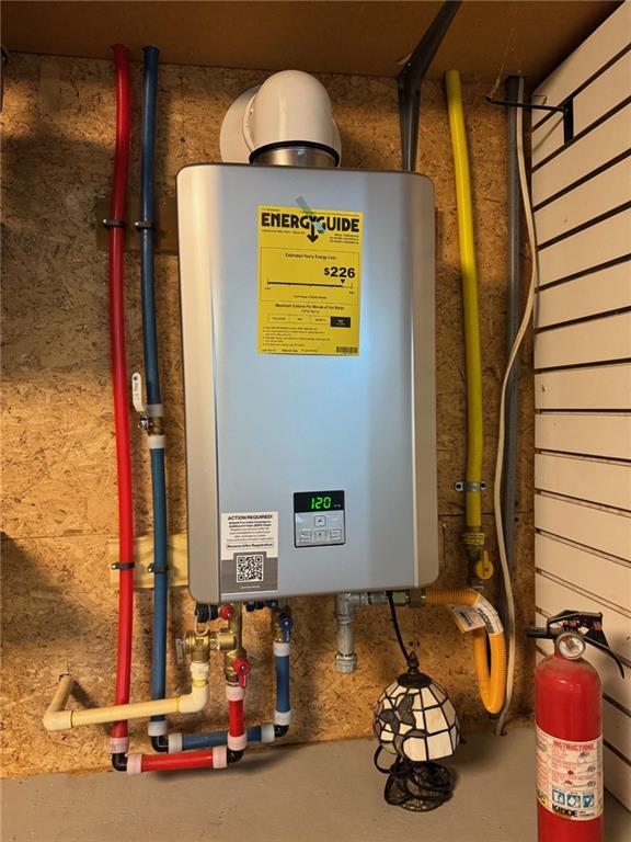 utility room with tankless water heater