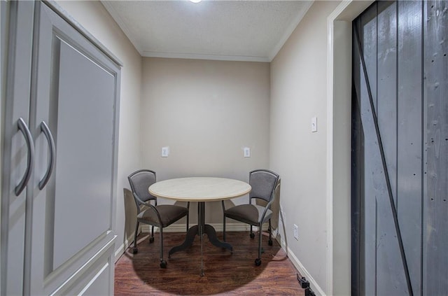 dining room featuring hardwood / wood-style flooring and crown molding