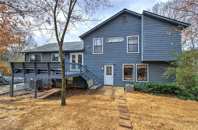 view of front facade with a wooden deck and a front lawn