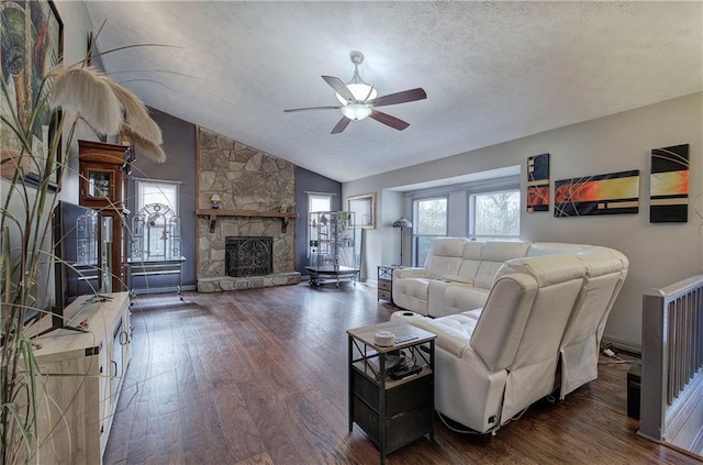 living room featuring a textured ceiling, vaulted ceiling, dark hardwood / wood-style floors, and a fireplace