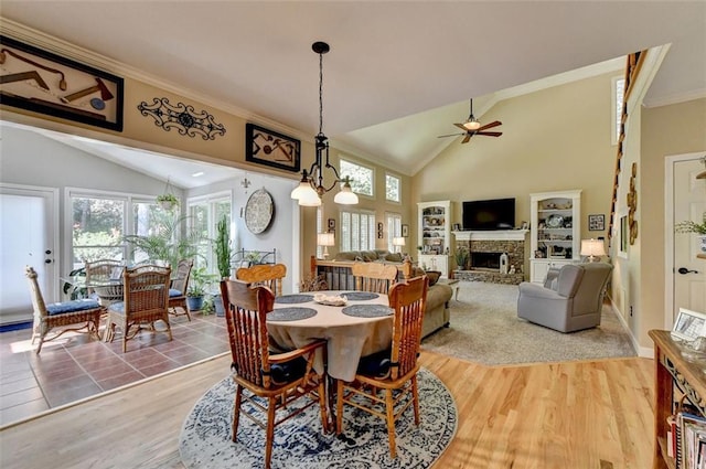 dining room featuring ornamental molding, lofted ceiling, hardwood / wood-style floors, and ceiling fan with notable chandelier