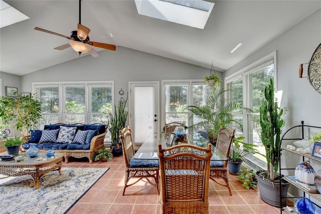 sunroom / solarium featuring lofted ceiling with skylight and ceiling fan