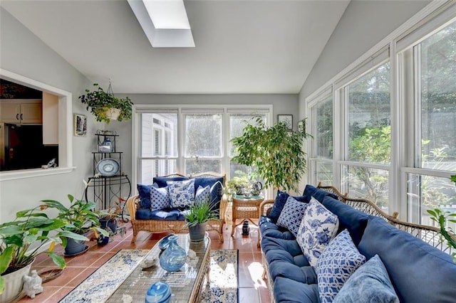 sunroom featuring vaulted ceiling with skylight