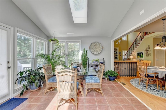 sunroom featuring lofted ceiling with skylight