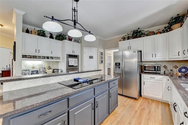 kitchen featuring hanging light fixtures, white cabinetry, gray cabinetry, and stainless steel appliances