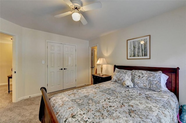 carpeted bedroom featuring a closet and ceiling fan