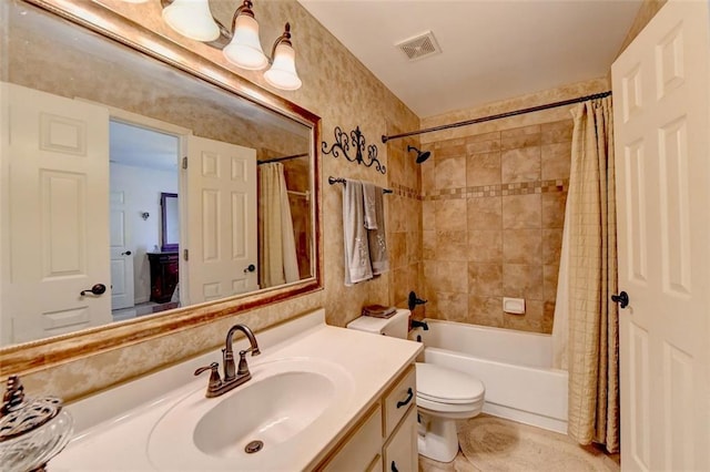 full bathroom with vanity, shower / bath combo with shower curtain, toilet, and tile patterned floors