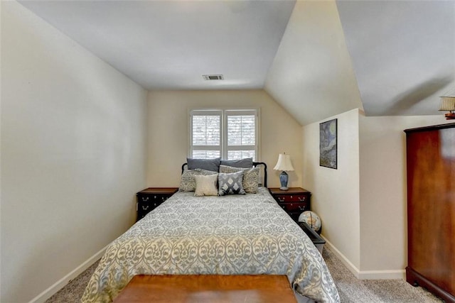 carpeted bedroom with vaulted ceiling