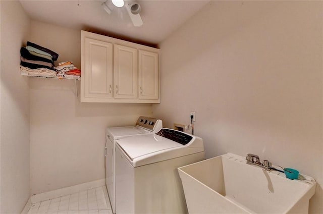 washroom with ceiling fan, cabinets, sink, and washing machine and clothes dryer