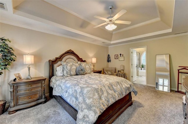 bedroom featuring carpet flooring, ensuite bath, a raised ceiling, ceiling fan, and crown molding