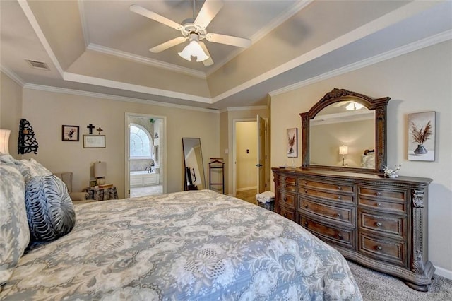 bedroom featuring connected bathroom, ceiling fan, carpet flooring, and a tray ceiling