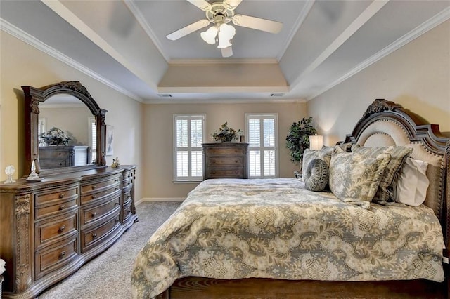 bedroom with crown molding, carpet floors, a raised ceiling, and ceiling fan