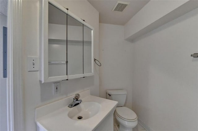 bathroom with toilet and vanity