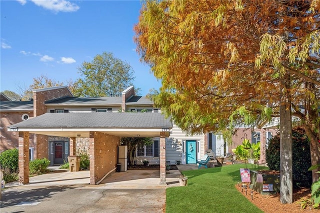 6500 Gaines Ferry Rd Unit E4, Flowery Branch, GA 30542 - rear view of house featuring a yard, concrete driveway, and brick siding