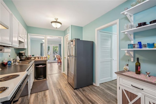 6500 Gaines Ferry Rd Unit E4, Flowery Branch, GA 30542 - kitchen with freestanding refrigerator, light wood-style floors, electric stove, and french doors