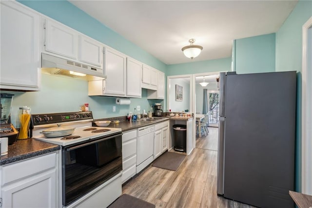 6500 Gaines Ferry Rd Unit E4, Flowery Branch, GA 30542 - kitchen with freestanding refrigerator, range with electric stovetop, under cabinet range hood, dishwasher, and dark countertops