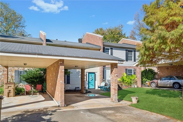 6500 Gaines Ferry Rd Unit E4, Flowery Branch, GA 30542 - view of front of property with a front yard, brick siding, and a carport