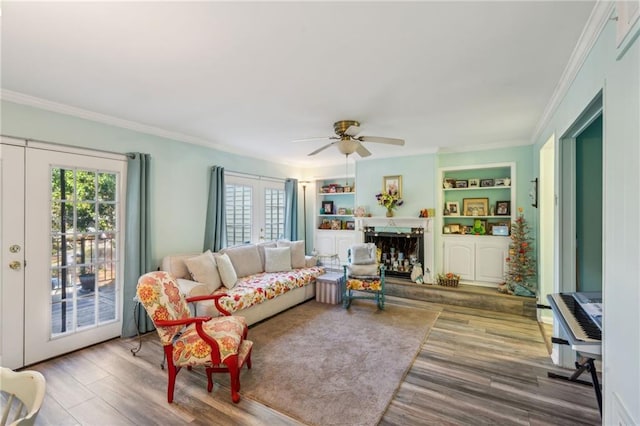 6500 Gaines Ferry Rd Unit E4, Flowery Branch, GA 30542 - living area with wood finished floors, healthy amount of natural light, crown molding, ceiling fan, and built in features