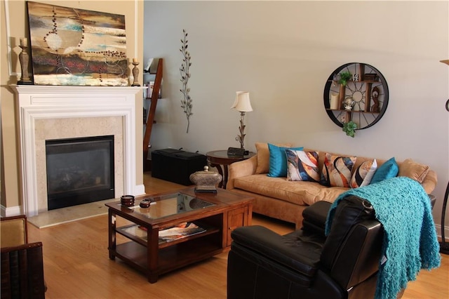 living room featuring a high end fireplace and wood finished floors