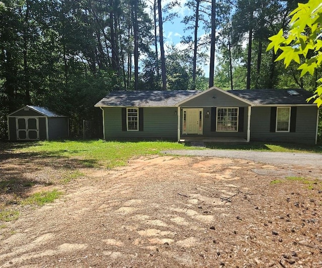 view of front of property featuring a storage shed