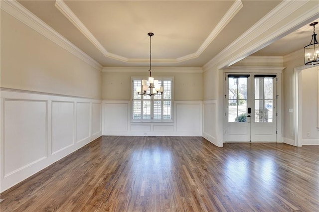 unfurnished dining area with dark wood-style flooring, a healthy amount of sunlight, and an inviting chandelier