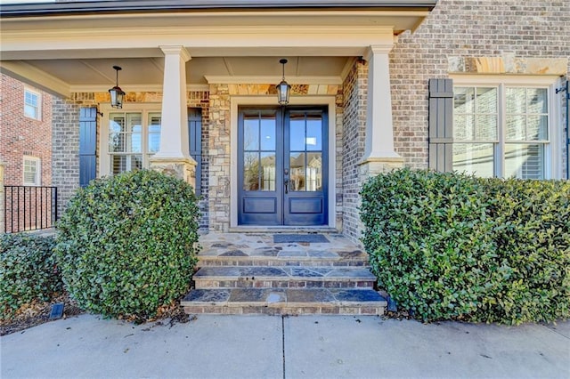 view of exterior entry with french doors and brick siding