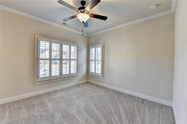 unfurnished room featuring baseboards, visible vents, crown molding, and carpet flooring