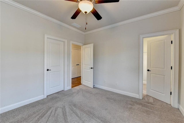 unfurnished bedroom with baseboards, carpet, and crown molding